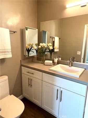 a bathroom with a toilet sink and mirror