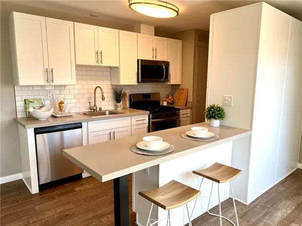 a kitchen with a stove a sink and a refrigerator