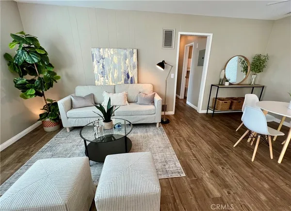 a living room with furniture rug and wooden floor