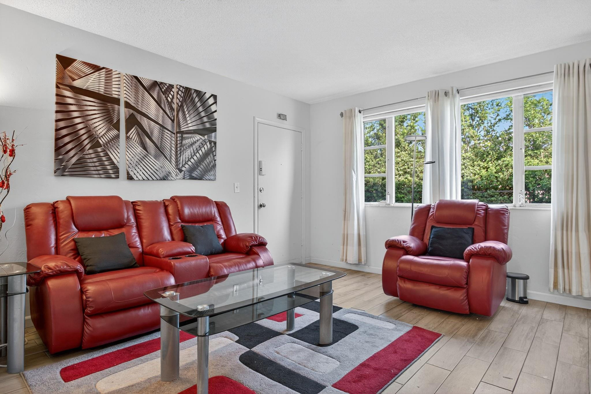 418 South Cypress Road, Unit 110 Pompano Beach, FL 33060 - Photo 3 of 28 a living room with furniture and a large window