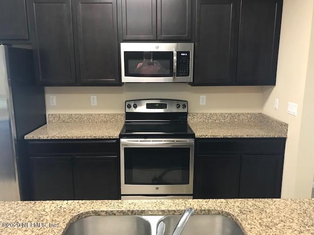 16498 Tisons Bluff Road Jacksonville, FL 32218 - Photo 3 of 37 a kitchen with a stove and a microwave