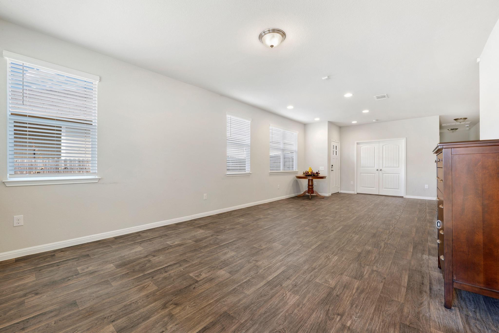 14409 Frankel Loop, Unit 33A Pflugerville, TX 78660 - Photo 11 of 28 a view of empty room with wooden floor and window