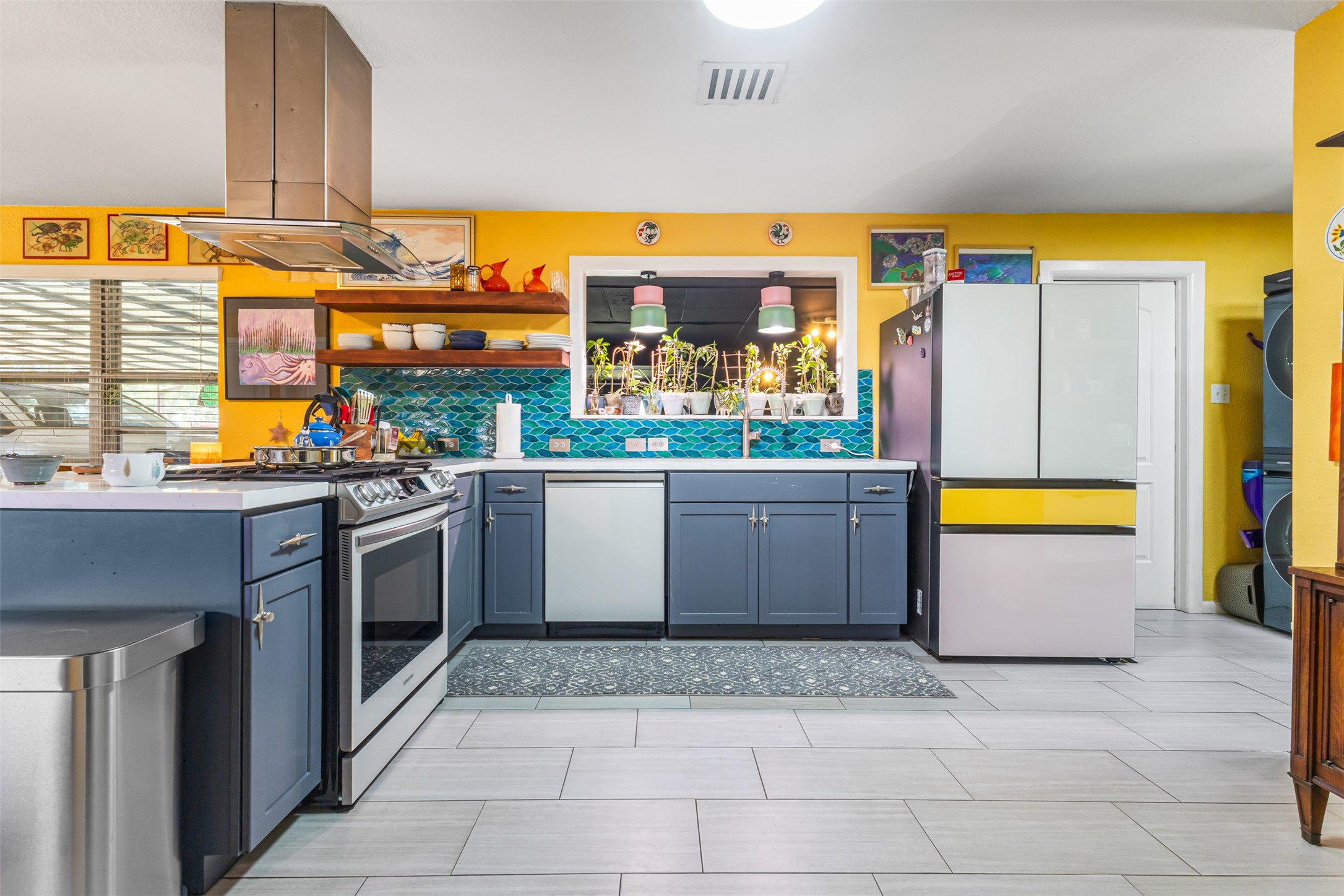 405 West 17th Street Georgetown, TX 78626 - Photo 7 of 21 a kitchen with stainless steel appliances a stove a sink and a microwave