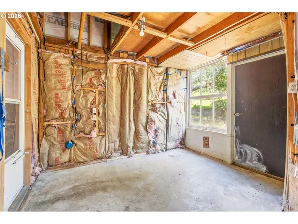 a view of a livingroom with furniture and a window