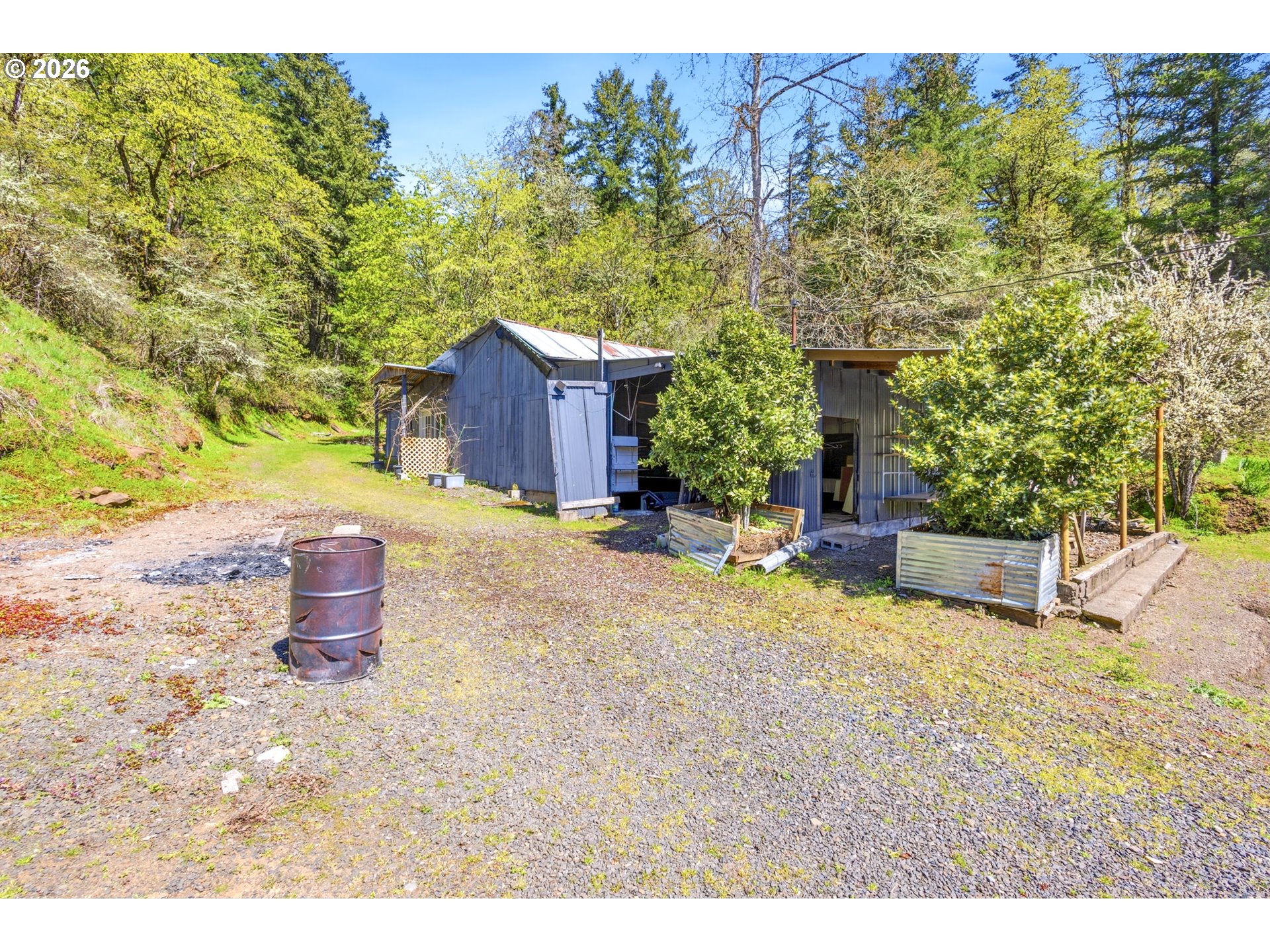 38775 Golden Valley Drive Lebanon, OR 97355 - Photo 19 of 36 a view of a backyard with table and chairs potted plants and large tree
