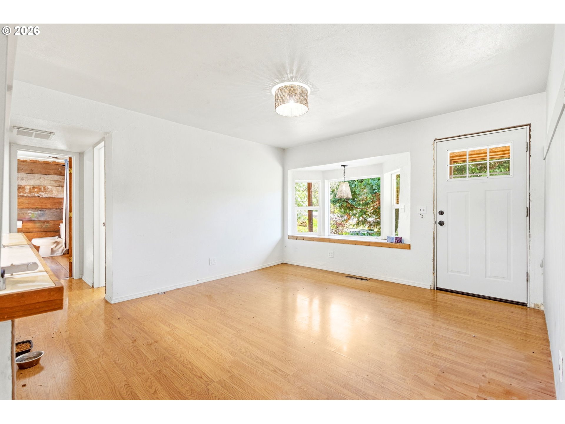 38775 Golden Valley Drive Lebanon, OR 97355 - Photo 32 of 36 an empty room with wooden floor and windows