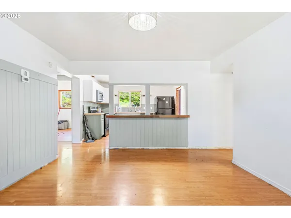 a kitchen with stainless steel appliances kitchen island granite countertop a refrigerator and a stove top oven