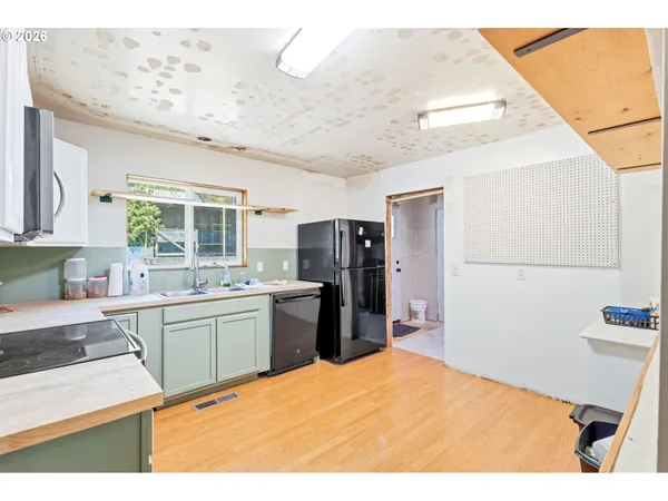 a kitchen with stainless steel appliances granite countertop a stove a sink dishwasher and a refrigerator