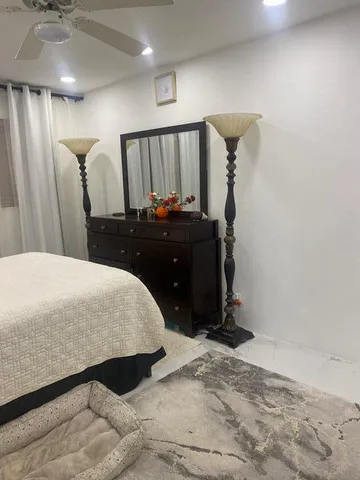 a bedroom with a bed and cabinets