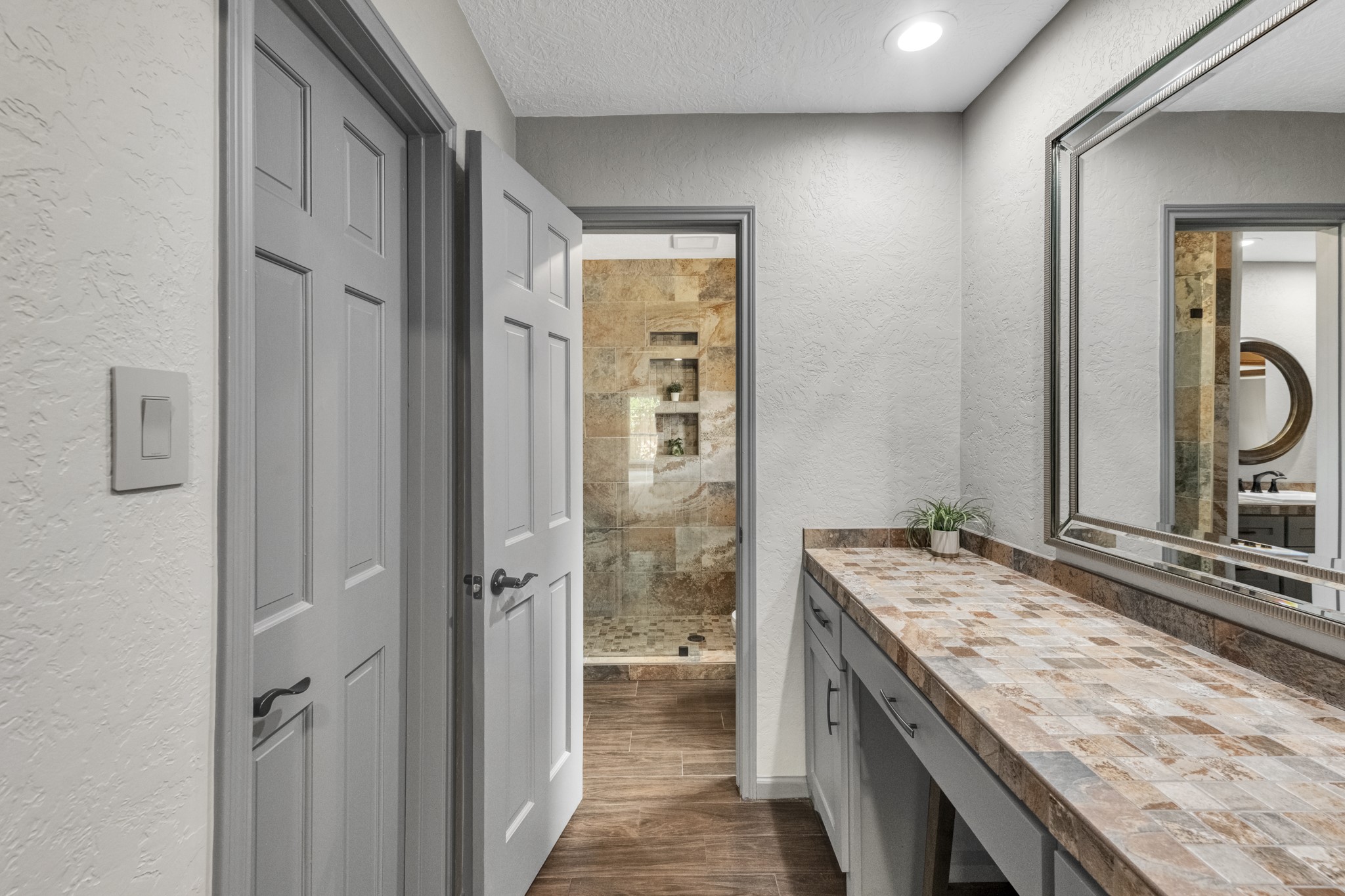 622 South Rivershire Drive Conroe, TX 77304 - Photo 28 of 44 a bathroom with a granite countertop sink a mirror and shower