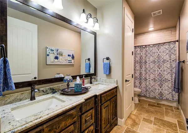 a bathroom with a double vanity sink and a mirror