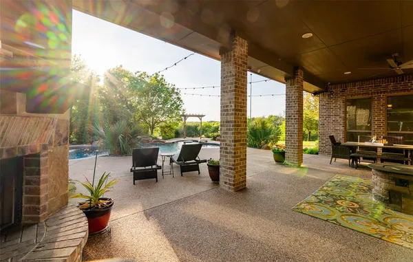 a living room with patio furniture and a potted plants