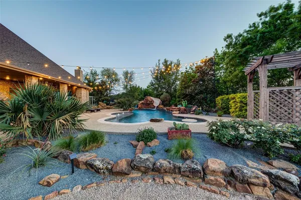 a view of backyard with outdoor seating and green space