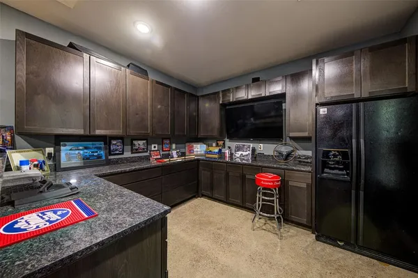a kitchen with stainless steel appliances granite countertop a refrigerator stove and sink