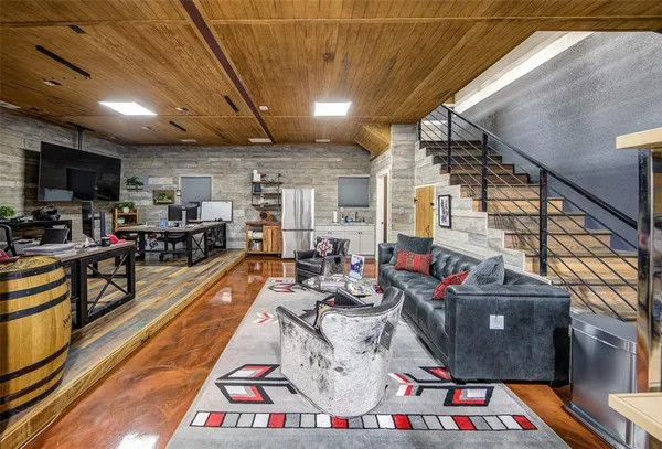 a living room with lots of furniture and kitchen view