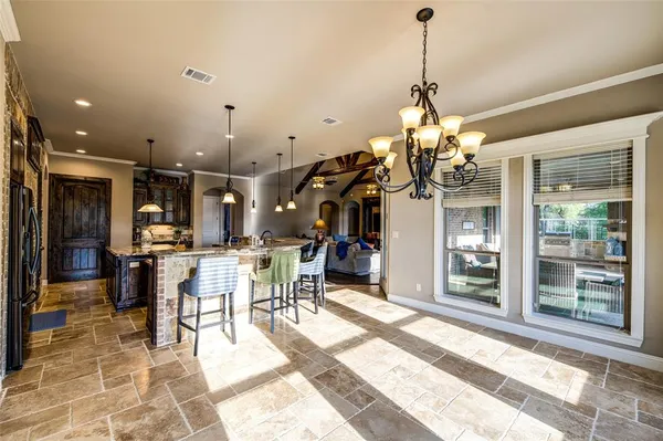 a view of a dining room with furniture and a chandelier