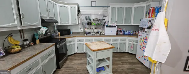a kitchen with a sink stove and cabinets