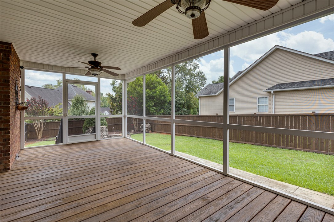 302 Wild Rice Drive Simpsonville, SC 29681 - Photo 35 of 44 Rich wood plank flooring anchors this screened porch overlooking a grassy backyard.