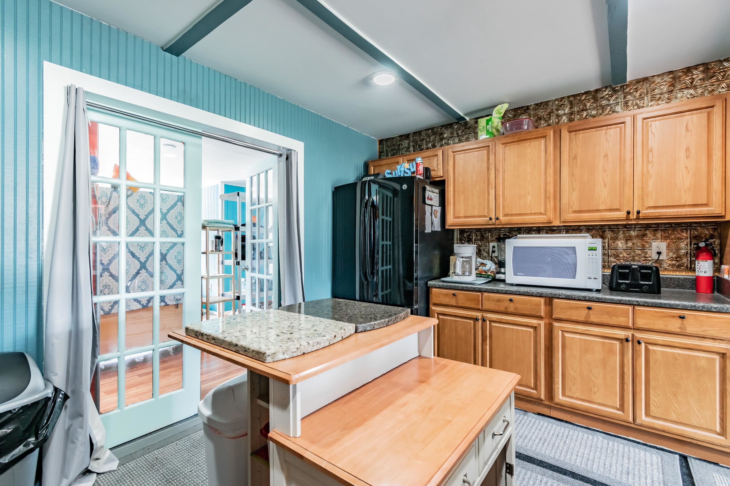 238 Cornell Road St. Augustine, FL 32086 - Photo 11 of 33 a kitchen with stainless steel appliances granite countertop a stove a sink dishwasher and a refrigerator with wooden floor