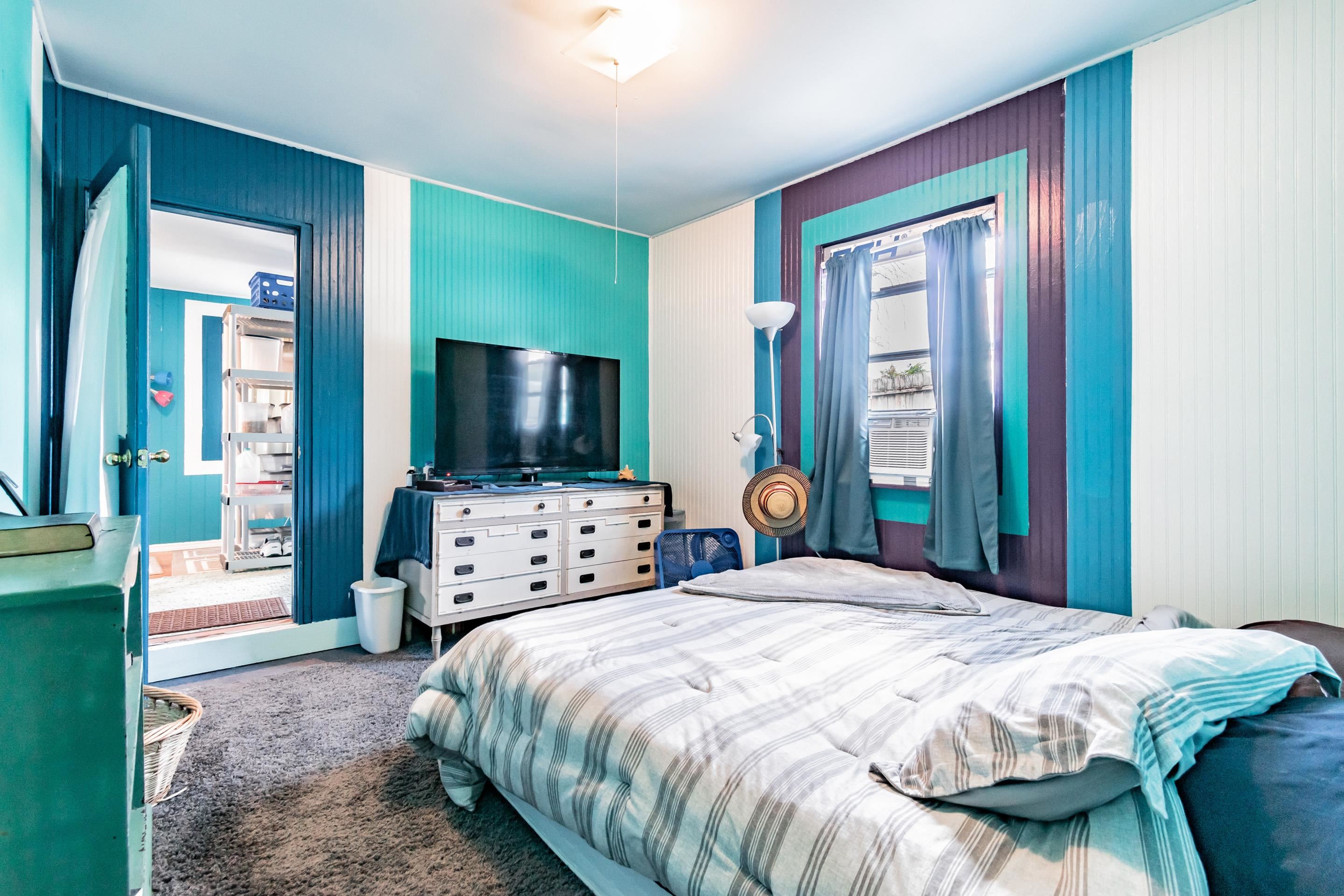 238 Cornell Road St. Augustine, FL 32086 - Photo 22 of 33 a bedroom with a large bed and a flat screen tv