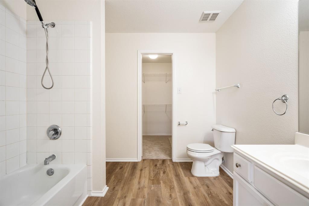 1626 White Oak Road Anna, TX 75409 - Photo 25 of 30 a bathroom with a white toilet and a shower