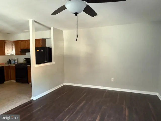 a view of a kitchen with wooden floor