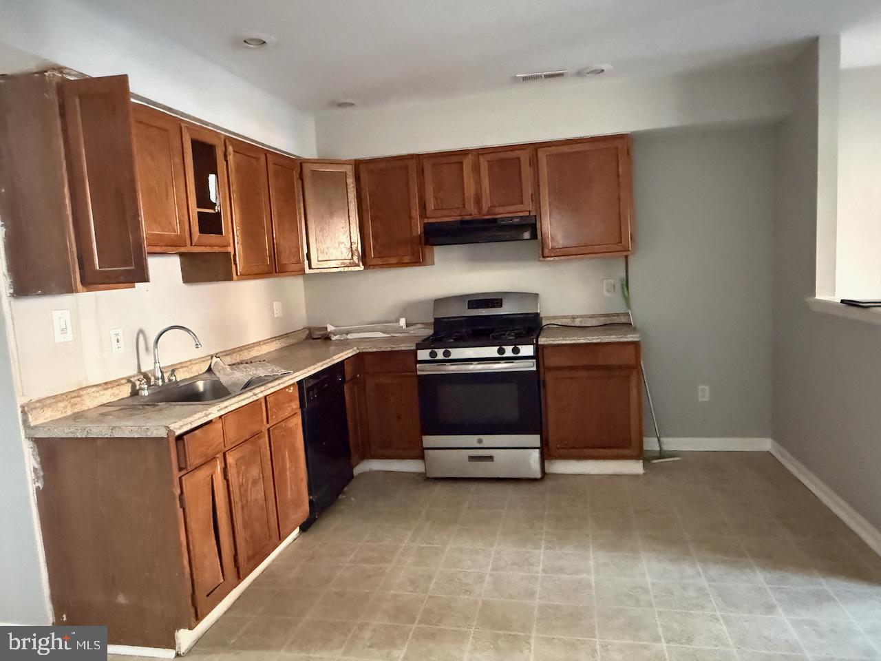 202 Robbins Street Philadelphia, PA 19111 - Photo 3 of 23 a kitchen with stainless steel appliances granite countertop a sink stove and cabinets
