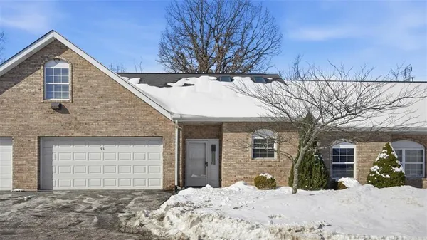 a front view of a house with a yard covered in snow