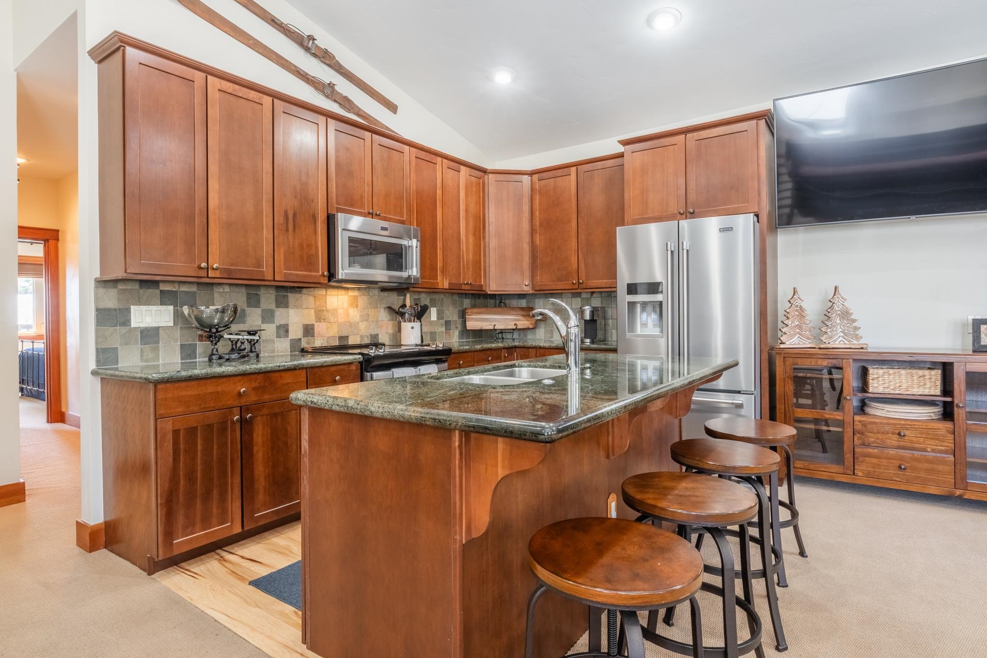 125 Davison Road, Unit 1 Mammoth Lakes, CA 93546 - Photo 6 of 46 a kitchen with stainless steel appliances granite countertop a stove a sink a refrigerator and chairs