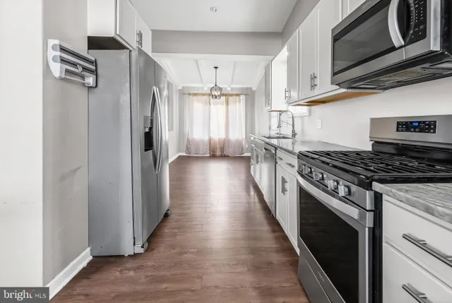a kitchen with stainless steel appliances granite countertop a stove and a refrigerator
