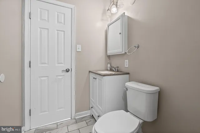 a white toilet sitting next to a bathroom sink