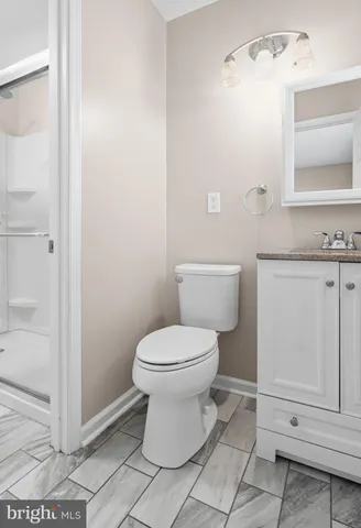 a bathroom with a toilet sink and vanity