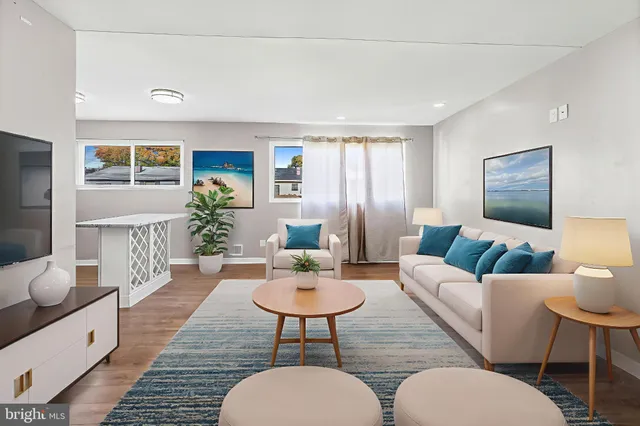 a living room with furniture and a wooden floor