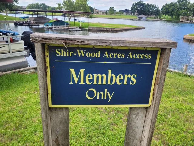 a view of outdoor space with a garden and signage