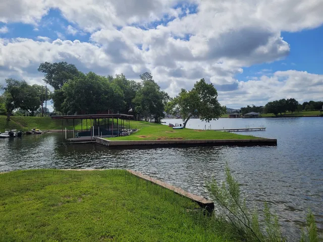 a view of a lake with houses in the back