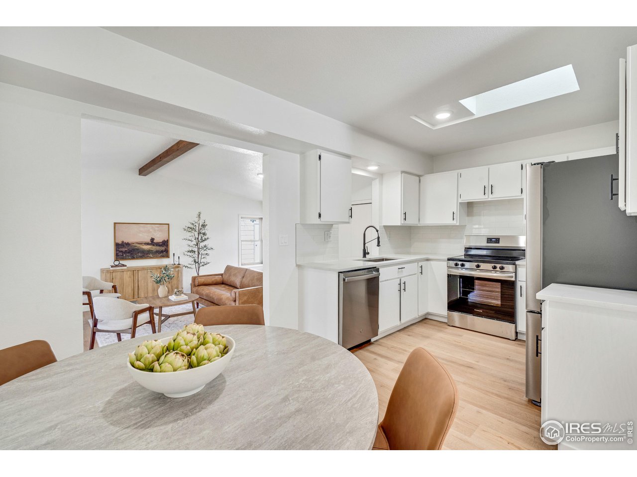 1115 2nd Street Road Eaton, CO 80615 - Photo 12 of 39 a kitchen with a white stove cabinets and a refrigerator