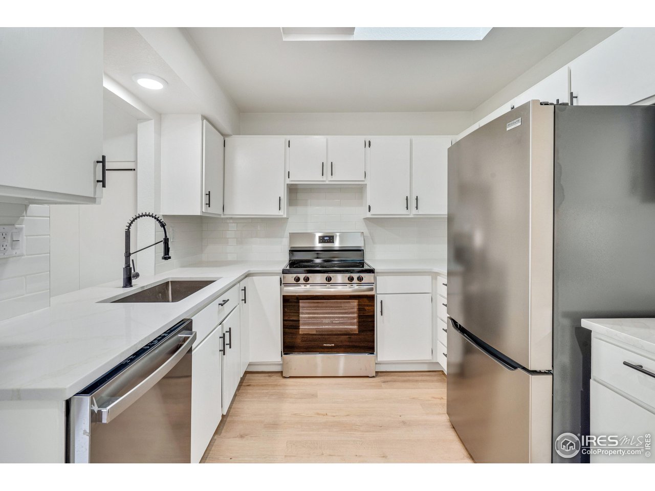 1115 2nd Street Road Eaton, CO 80615 - Photo 13 of 39 a kitchen with stainless steel appliances granite countertop a refrigerator sink and stove
