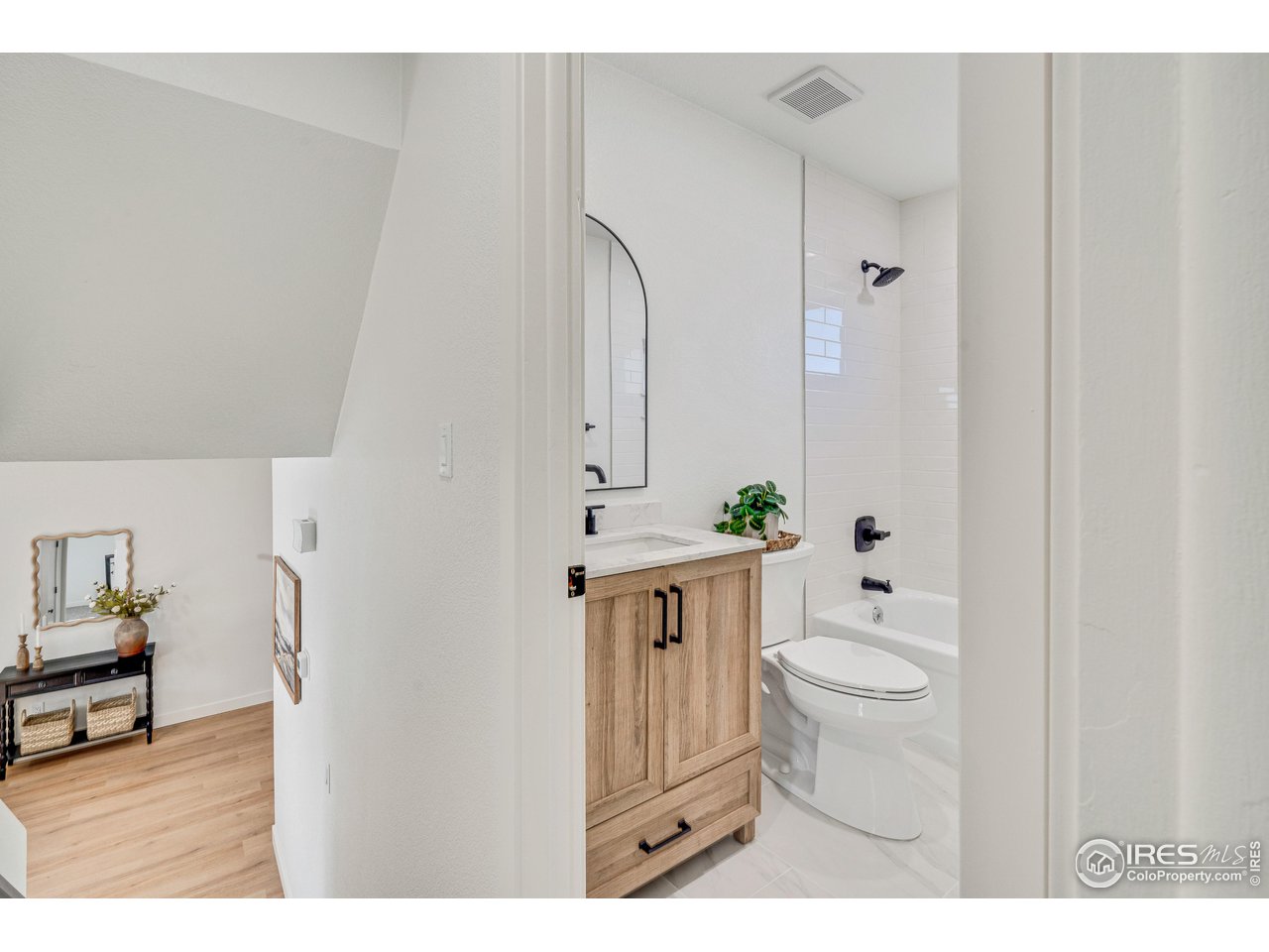 1115 2nd Street Road Eaton, CO 80615 - Photo 27 of 39 a bathroom with a granite countertop sink a toilet a mirror and shower