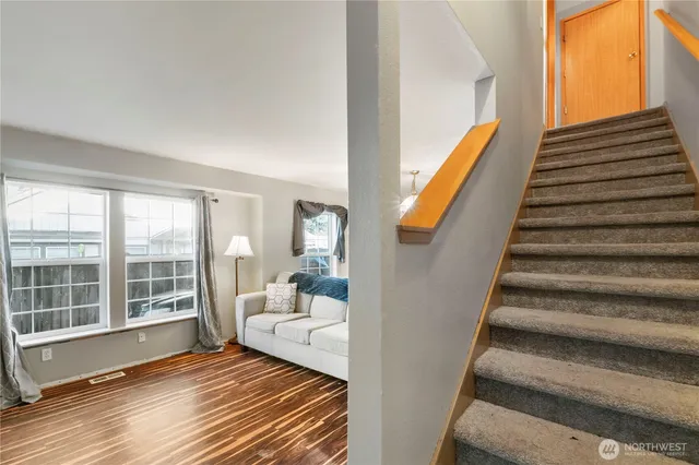 a view of a room with wooden floor and windows