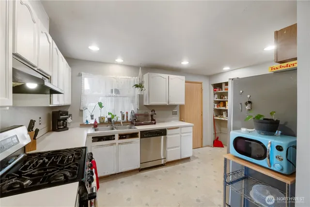 a kitchen with a sink a stove and cabinets
