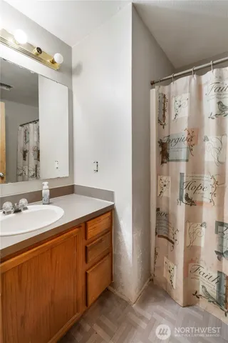 a bathroom with a granite countertop sink and a mirror
