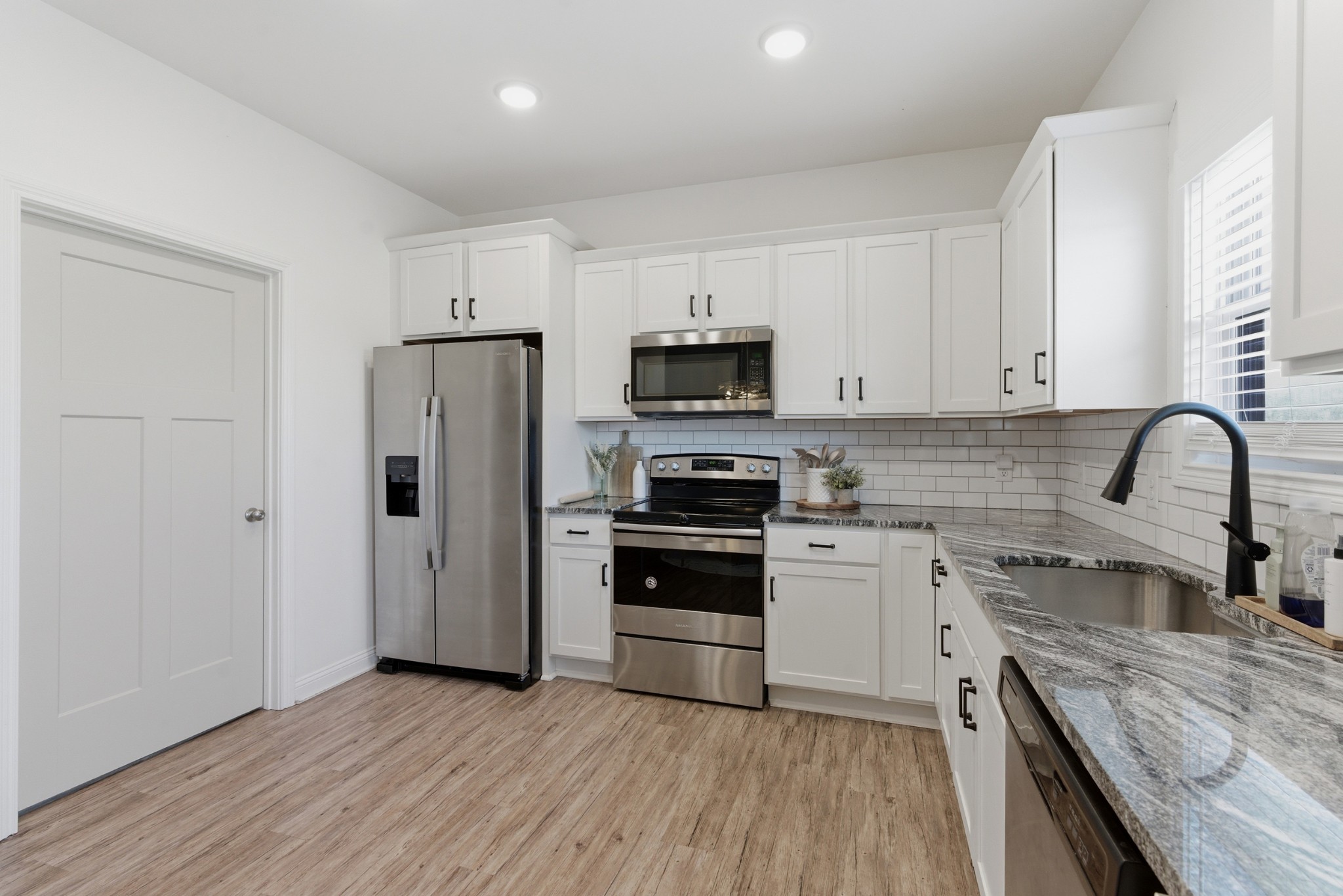 1502 Rock Bridge Road Bethpage, TN 37022 - Photo 11 of 40 a kitchen with a sink cabinets and stainless steel appliances