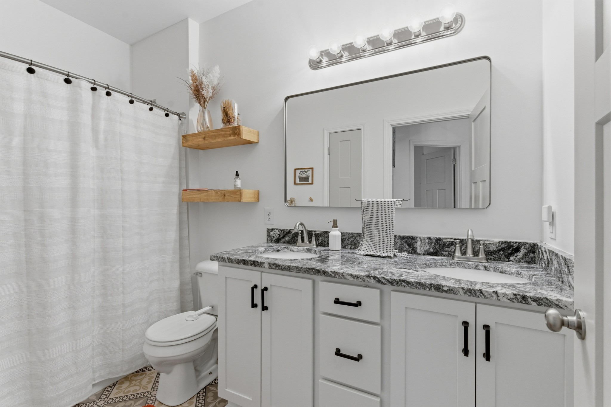 1502 Rock Bridge Road Bethpage, TN 37022 - Photo 14 of 40 a bathroom with a granite countertop sink toilet and mirror