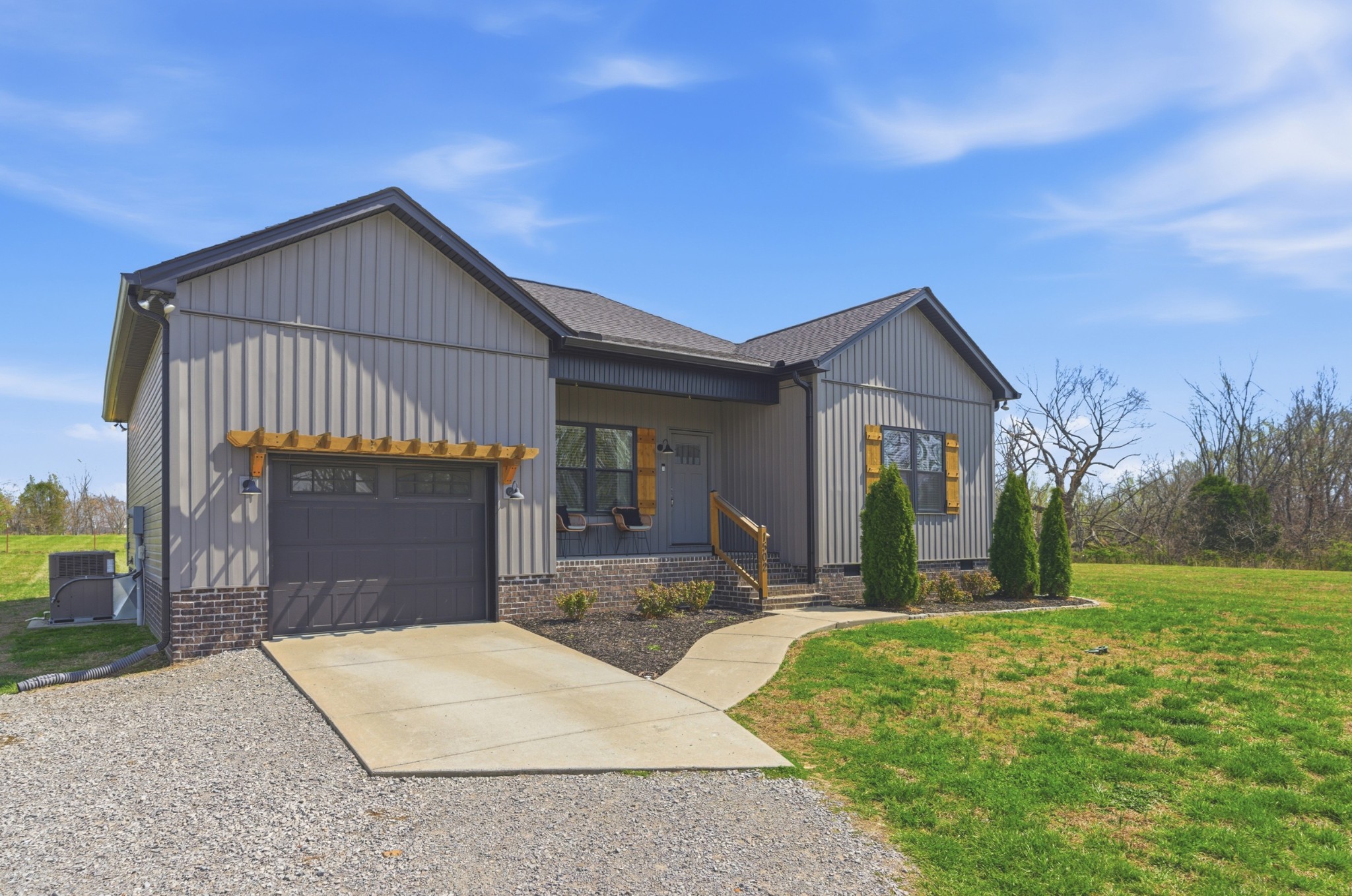 1502 Rock Bridge Road Bethpage, TN 37022 - Photo 3 of 40 a front view of a house with a yard and garage