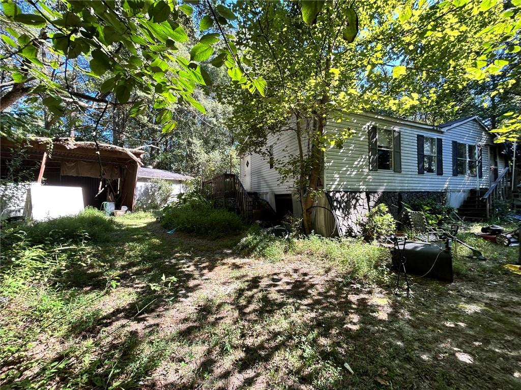 31 Creekwood Road Winder, GA 30680 - Photo 12 of 14 a backyard of a house with yard and trampoline