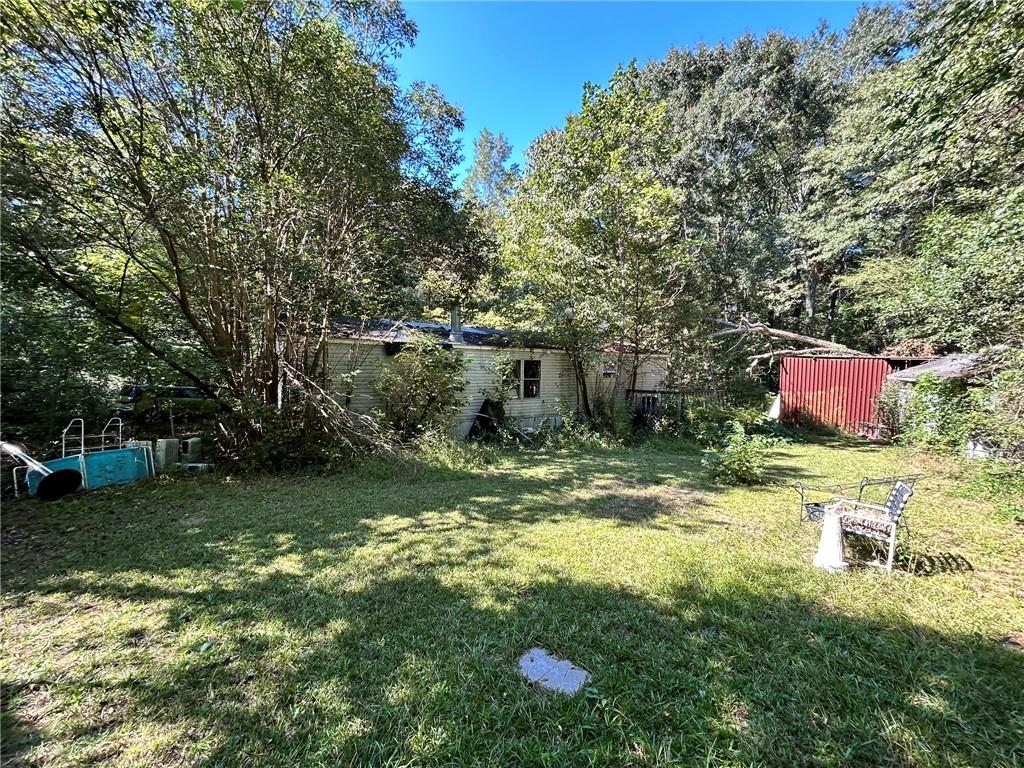 31 Creekwood Road Winder, GA 30680 - Photo 13 of 14 a backyard of a house with table and chairs
