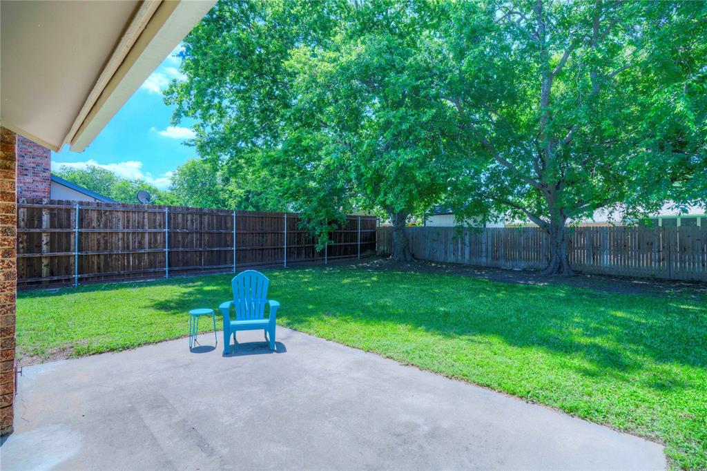6028 Ridgecrest Drive Watauga, TX 76148 - Photo 33 of 40 a garden with plants and large trees