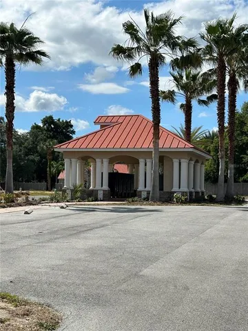 a front view of a house with a yard and parking