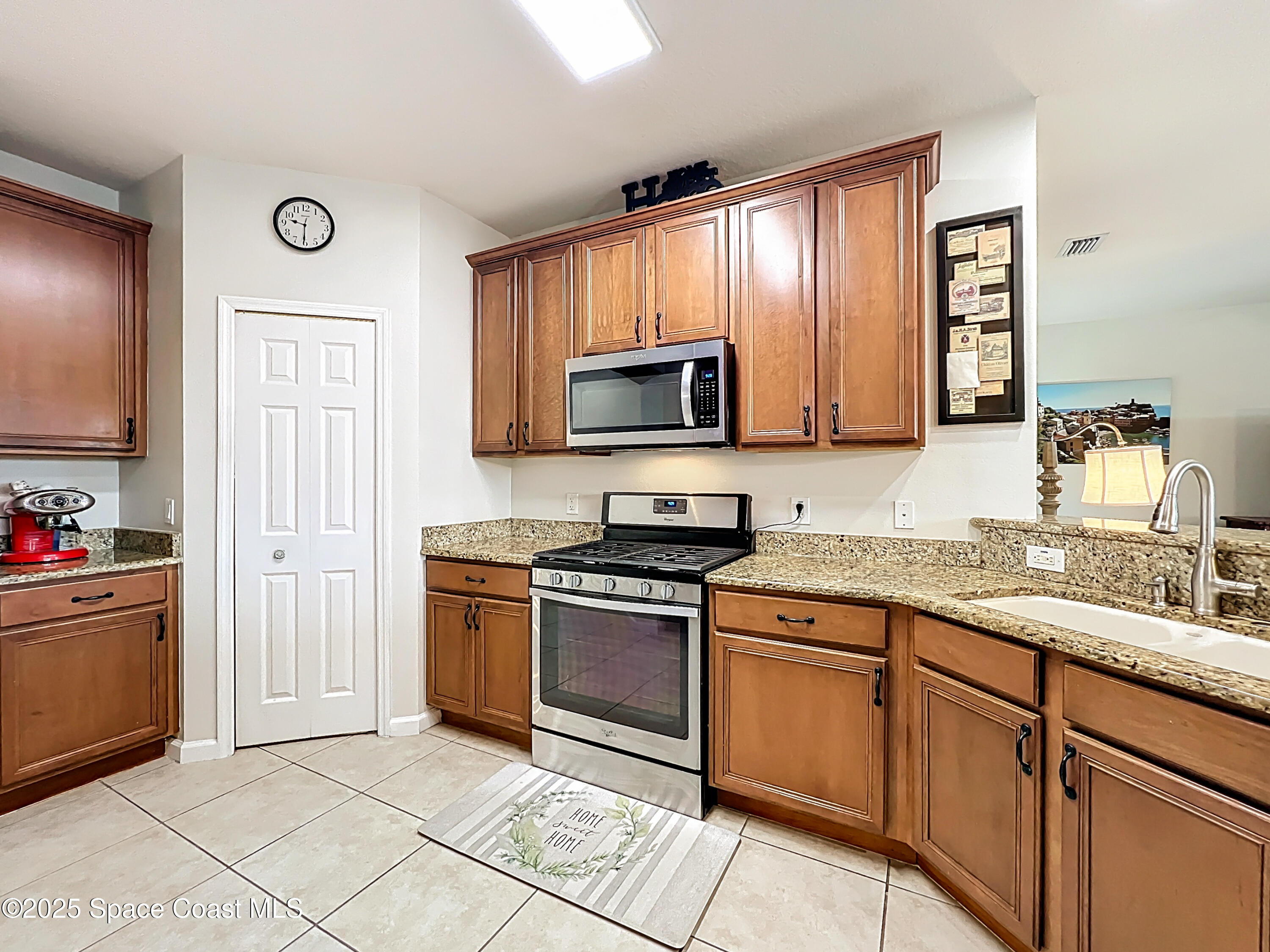 1110 Bolle Circle Rockledge, FL 32955 - Photo 11 of 39 a kitchen with stainless steel appliances granite countertop a stove microwave and sink