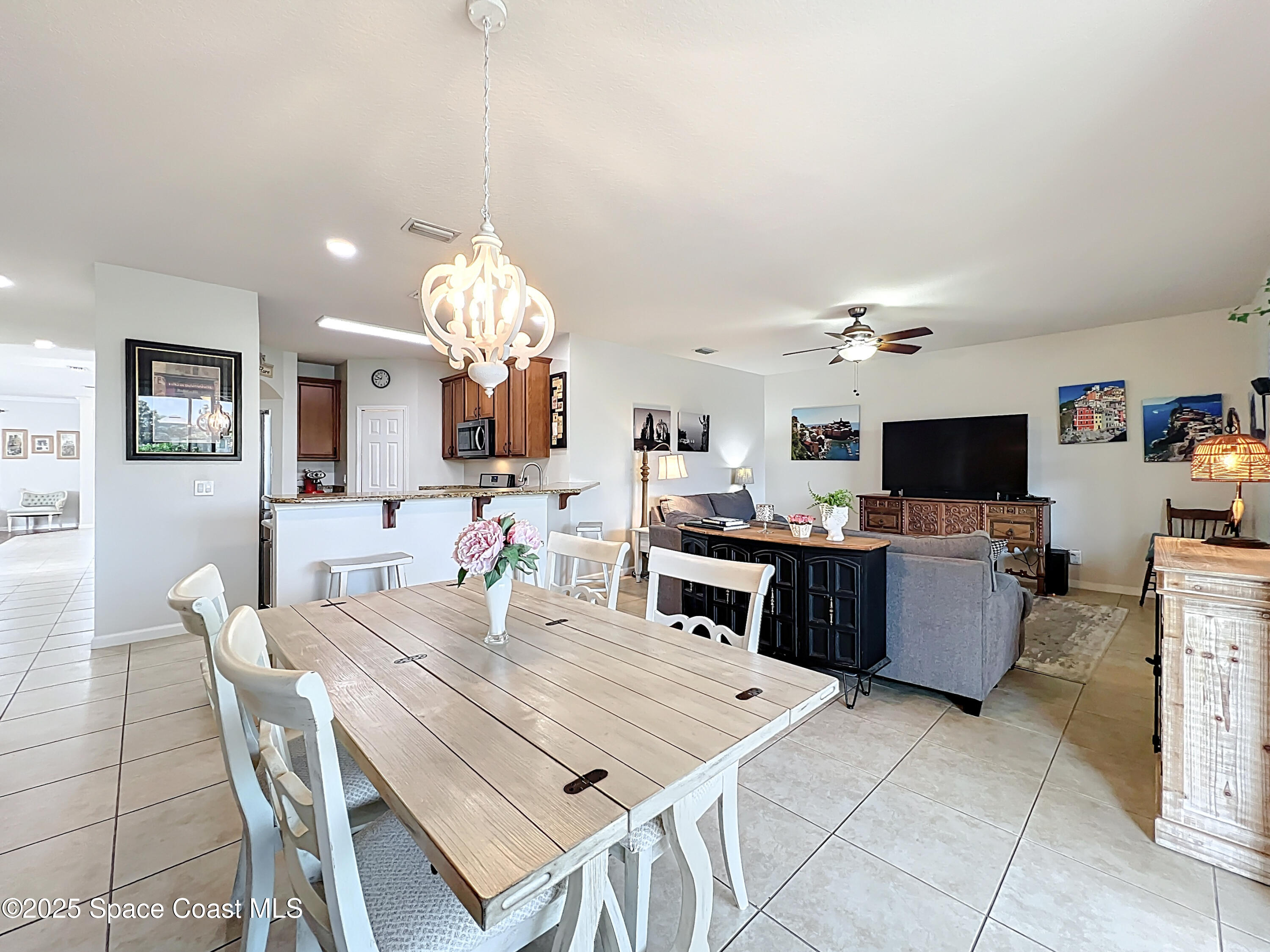 1110 Bolle Circle Rockledge, FL 32955 - Photo 13 of 39 a view of a dining room with furniture and a flat screen tv